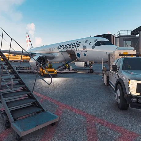 Brussels Airlines aircraft at a gate, beside stairs and ground vehicles in a flight simulator.